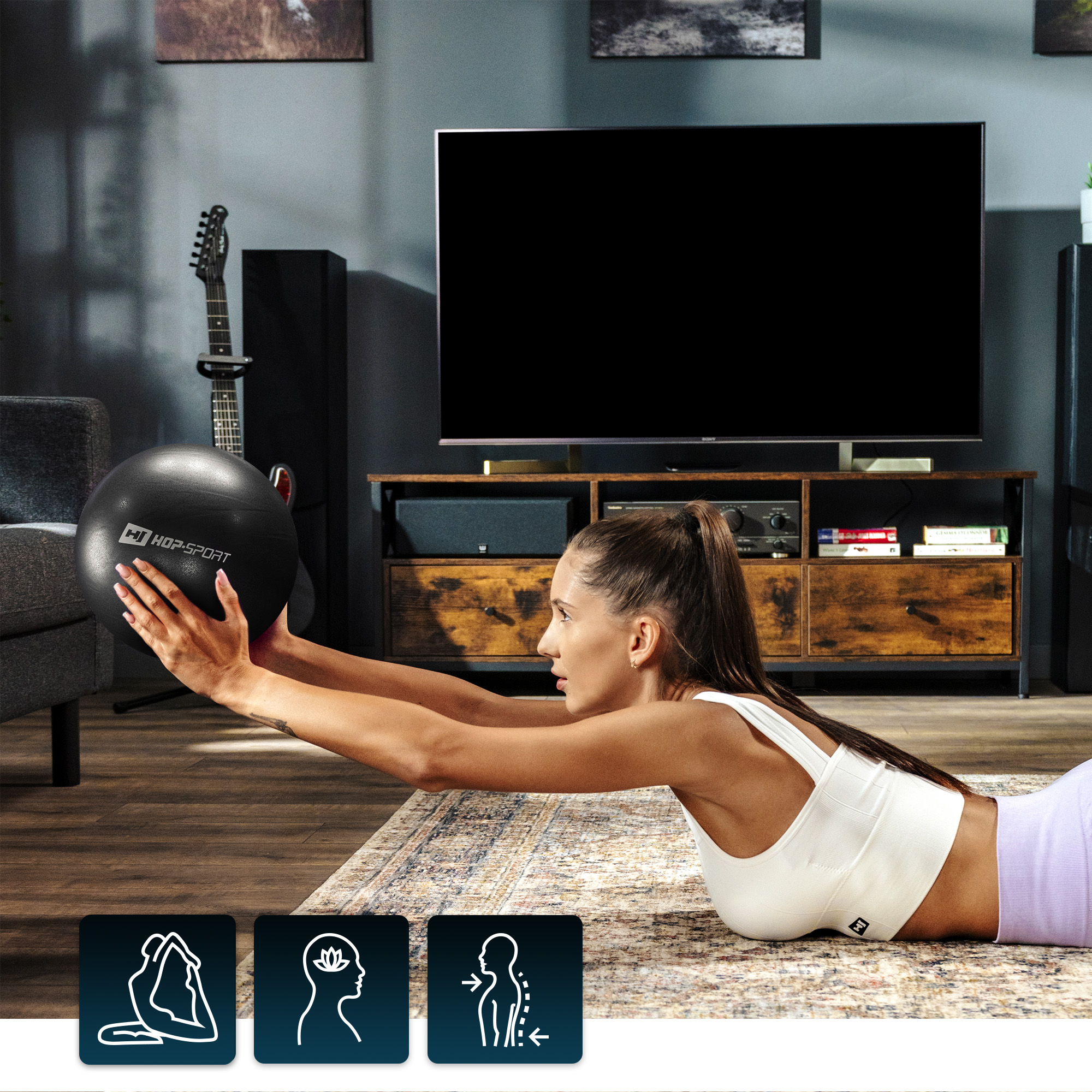 Modella esegue sollevamenti con palla nera da pilates Hop-Sport