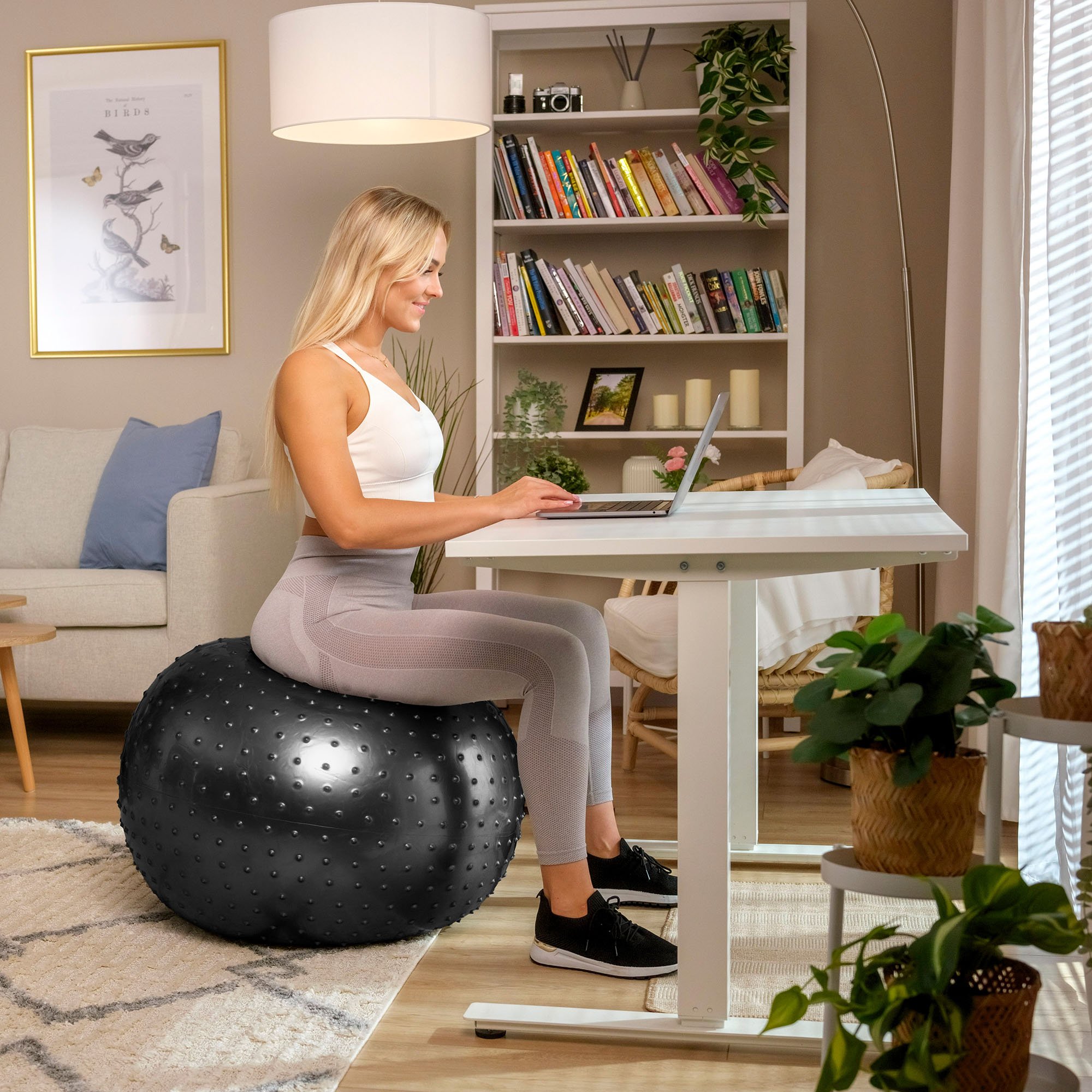 Donna utilizza la palla nera con rilievi per lavorare alla scrivania